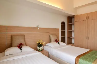 two beds sitting next to each other in a bedroom at One-Stop Residence & Hotel in Kuala Lumpur