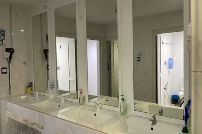 a bathroom with three sinks and a large mirror at OYO 91036 J CAPSULE HOTEL @ JALAN BUKIT BINTANG in Kuala Lumpur