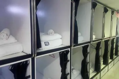 a locker room with a bunch of towels and mirrors at OYO 91036 J CAPSULE HOTEL @ JALAN BUKIT BINTANG in Kuala Lumpur