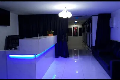 a lobby with a reception desk with blue lights at OYO 91036 J CAPSULE HOTEL @ JALAN BUKIT BINTANG in Kuala Lumpur