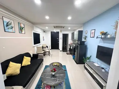 a living room with a couch and a table at Taragon Service Apartment- Next To LaLaport BBCC in Kuala Lumpur