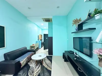 a living room with a couch and a tv at Taragon Service Apartment- Next To LaLaport BBCC in Kuala Lumpur