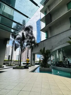 a building with a pool in the middle of a courtyard at Urban Suites @ Swiss Garden Residence in Kuala Lumpur