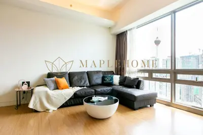 a living room with a black couch and a large window at SG Residence Kuala Lumpur in Kuala Lumpur