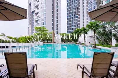 a swimming pool with two chairs and some buildings at SG Residence Kuala Lumpur in Kuala Lumpur