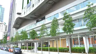 a large building with cars parked in front of it at The Robertson KL in Kuala Lumpur