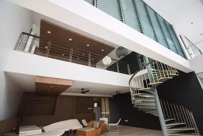 a spiral staircase in a building with a living room at The Robertson KL in Kuala Lumpur
