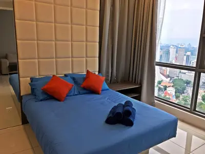 a bed with two pairs of shoes sitting on it at The Robertson KL in Kuala Lumpur