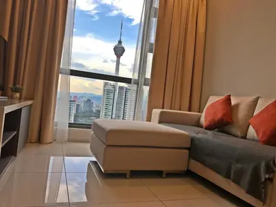 a living room with a couch and a large window at The Robertson KL in Kuala Lumpur