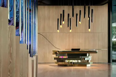 a dining room with a table and chandeliers at W Kuala Lumpur in Kuala Lumpur