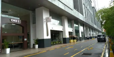 a truck is parked in front of a building at Imperial Regency Suites & Petaling Jaya in Kuala Lumpur