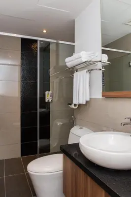 a bathroom with a white sink and a toilet at Imperial Regency Suites & Petaling Jaya in Kuala Lumpur