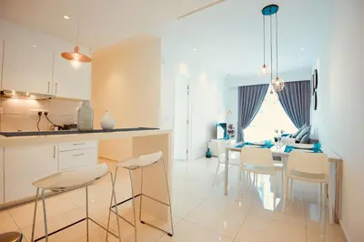 a kitchen and dining room with a table and chairs at Robertson Suites Kuala Lumpur in Kuala Lumpur