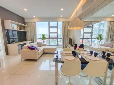 a living room with a dining table and chairs at Robertson Suites Kuala Lumpur in Kuala Lumpur