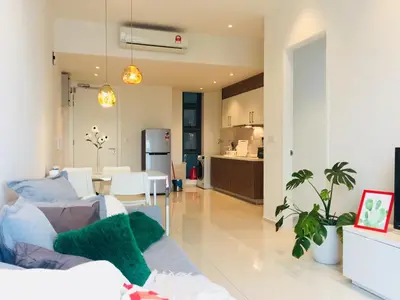 a living room with a couch and a kitchen at Robertson Suites Kuala Lumpur in Kuala Lumpur