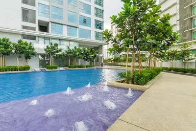 a swimming pool in a building with birds in the water at Robertson Suites Kuala Lumpur in Kuala Lumpur