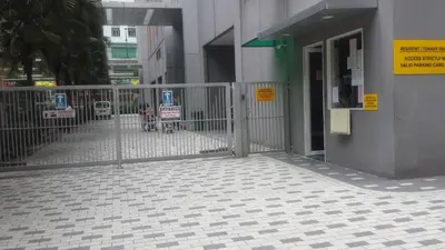 a gate with a sign in front of a building at Soho Suites KL City Centre in Kuala Lumpur