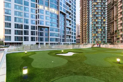 a golf course in the middle of some tall buildings at Robertson Suites by Airhost in Kuala Lumpur