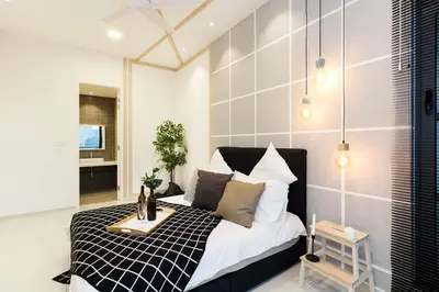 a bedroom with a black and white bed in a room at Robertson Suites by Airhost in Kuala Lumpur