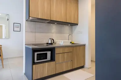 a kitchen with a sink and a microwave at Robertson Suites by Airhost in Kuala Lumpur