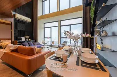 a living room with a table and a couch at Expressionz KLCC by Wodages in Kuala Lumpur