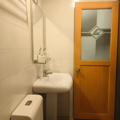 a bathroom with a sink and a toilet and a mirror at LEO Express Hotel in Kuala Lumpur