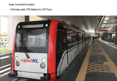 a red and white train at a train station at LEO Express Hotel in Kuala Lumpur