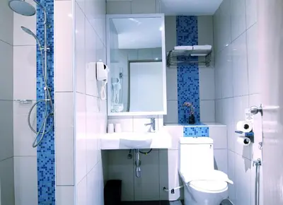 a bathroom with a sink and a toilet and a mirror at Pacific Express Hotel Chinatown in Kuala Lumpur