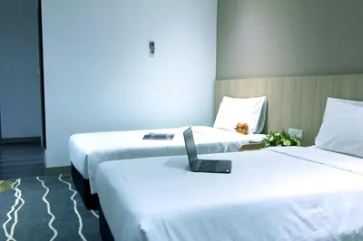 two beds sitting next to each other in a room at Pacific Express Hotel Chinatown in Kuala Lumpur