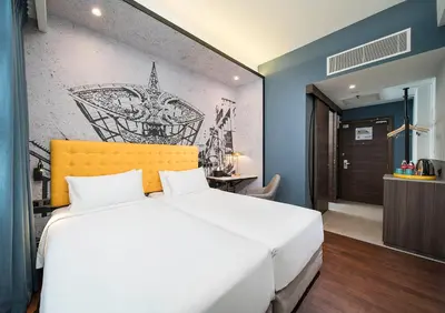 a bedroom with a white bed and a drawing on the wall at Travelodge Kuala Lumpur City Centre in Kuala Lumpur