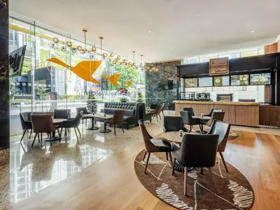 a restaurant with tables and chairs in a building at ibis Kuala Lumpur City Centre in Kuala Lumpur