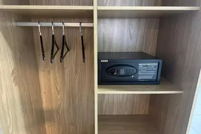 a cabinet with a microwave and a radio in it at Poorna Hotel at Jalan Ipoh Sentul Kuala Lumpur in Kuala Lumpur