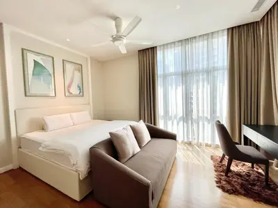 a bedroom with a bed and a couch and a desk at KLCC Luxury Condo Damai 88 Near Gleneagles Hospital in Kuala Lumpur