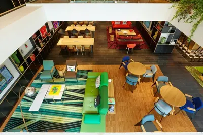 an overhead view of a restaurant with tables and chairs at citizenM Kuala Lumpur in Kuala Lumpur