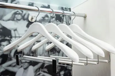 a bunch of white utensils hanging on a rack at citizenM Kuala Lumpur in Kuala Lumpur