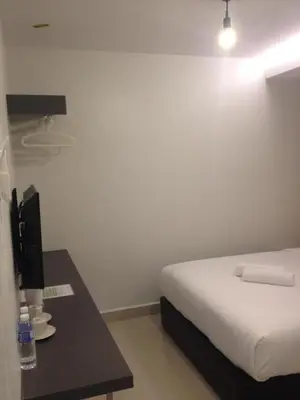 a hotel room with a bed and a desk with a bed sidx sidx at Festival Boutique Hotel @ Kampung Pandan in Kuala Lumpur