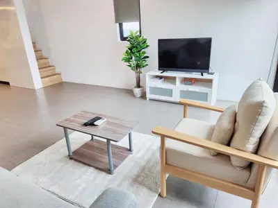 a living room with a couch and a coffee table at The Establishment Bangsar in Kuala Lumpur