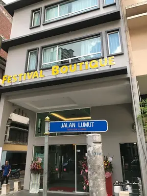 a blue street sign in front of a building at Festival Boutique Hotel - Damai Complex in Kuala Lumpur