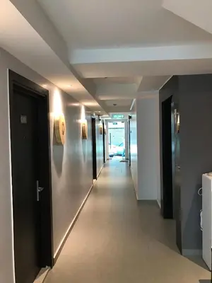 a hallway in a building with a hallway leading to a room at Festival Boutique Hotel - Damai Complex in Kuala Lumpur
