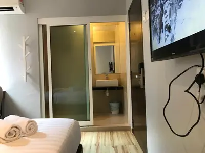 a hotel room with a television and a bedroom at Festival Boutique Hotel - Damai Complex in Kuala Lumpur
