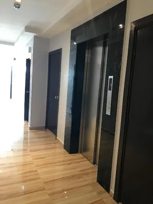 a hallway with black doors and a wooden floor at Festival Boutique Hotel - Damai Complex in Kuala Lumpur