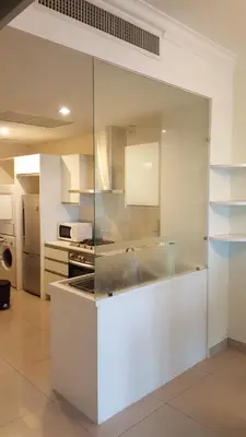 a kitchen with white cabinets and a white counter top at 1room Publika in Kuala Lumpur