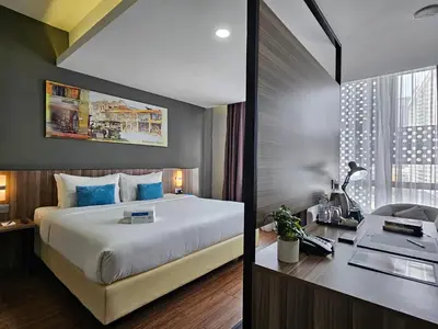 a hotel room with a large bed and a desk at Days Hotel & Suites by Wyndham KL - Chan Sow Lin MRT or LRT in Kuala Lumpur