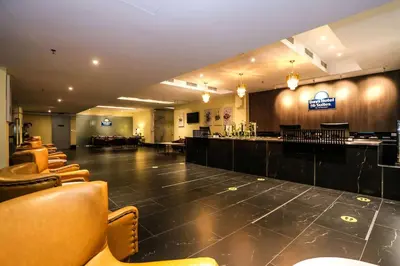 a large room with a bar and some chairs at Days Hotel & Suites by Wyndham KL - Chan Sow Lin MRT or LRT in Kuala Lumpur