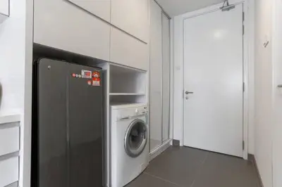 a laundry room with a washing machine and a door at Perfect Location@ Heart of KL City Centre next to Metro MRT in Kuala Lumpur