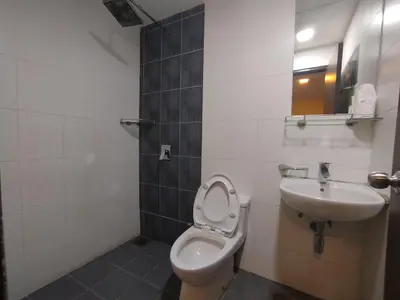 a bathroom with a toilet and a sink at Hotel De Grand Orchard in Kuala Lumpur