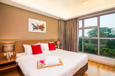 a hotel room with a bed and a large window at Suasana Bukit Ceylon by Plush in Kuala Lumpur