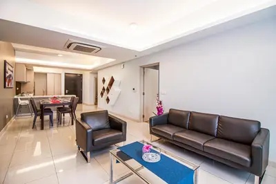 a living room with a couch and chairs and a table at Suasana Bukit Ceylon by Plush in Kuala Lumpur