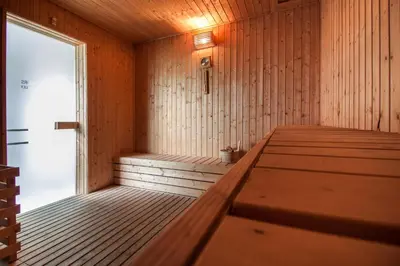 a sauna with a wooden floor and a door at Suasana Bukit Ceylon by Plush in Kuala Lumpur
