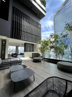 a building with a patio with tables and chairs at Maxhome at Lucentia Bukit Bintang City centre KL in Kuala Lumpur